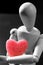 Wooden mannequin holding a red jelly heart shape