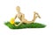Wooden mannequin lying on lawn with plush chicken