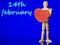 Wooden mannequin with red heart on blue color background and 14th February blurred sing in the background, Saint Valentine theme