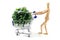 Wooden mannequin shopping garden utensils in a shopping cart at