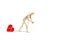 A wooden mannequin toy dragging a red textile heart with a chain