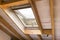 Wooden mansard or skylight window on attic. Attic renovation and