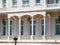 Wooden mansion close up detail. Beautiful classic architecture balcony with arch,  columns and many windows