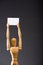 Wooden marionette holding blank placard on