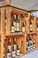 A wooden market stall selling bottles of various edible oils