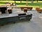 wooden massive park bench shape block with metal legs on granite