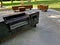 wooden massive park bench shape block with metal legs on granite