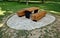 wooden massive park bench shape block with metal legs on granite