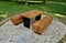 wooden massive park bench shape block with metal legs on granite