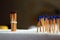 Wooden matches standing. Brown match tied by a rubber band rope and the blue matches standing in distance. Freedom concept.