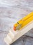 Wooden materials and measuring meter yellow pencil