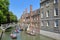 Wooden Mathematical Bridge at Queens College University with tourists and students punting on the river Cam