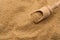 Wooden measuring spoon in brown cane sugar closeup