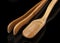 A wooden measuring spoon, tea tongs on a black background, a Chinese tea party