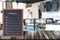 Wooden menu display sign, Frame restaurant message board on wooden table, Blurred image background.