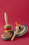 Wooden mexican toys against red background