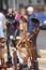 Wooden mini sculptures put up for sale during street fair, blurred people on a background