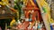 Wooden miniature guardian spirit house. Small buddhist temple shrine, colorful flower garlands. San phra phum.