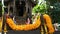 Wooden miniature guardian spirit house. Small buddhist temple shrine, colorful flower garlands. San phra phum erected to