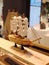 Wooden model of sailing boat with white sails