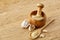 Wooden mortar and pestle with garlic and grind spicies on rustic table, close-up, selective focus