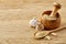 Wooden mortar and pestle with ginger and grind spicies on rustic table, close-up, selective focus