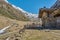 Wooden mountain hut between snowy mountain peaks. Wooden mountain cabin in the alps. Lonely chalet in the mountains in South Tyrol