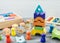 Wooden multicolored toy house, pyramid, blocks on wooden table. Back to school, games for kindergarten, preschool education