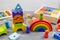 Wooden multicolored toy house, pyramid, blocks on wooden table. Back to school, games for kindergarten, preschool education