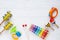 Wooden musical instruments: xylophone, trumpet, maracas, bells, tambourine on white wooden background. Top view.