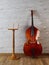 Wooden musical mockup poster stand and contrabass in retro inter