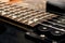 Wooden neck of a black guitar close up