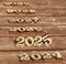 wooden number 2025 with 2024 and 2026 2027 2028 2029 in the sun on a sunny day