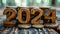 Wooden numbers 2024 and coins on a wooden background. New year concept