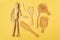 Wooden objects with a wooden mannequin on a yellow background. Zero waste concept. Eco friendly reusable items.