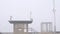 Wooden Ocean Beach pier in fog, misty calm boardwalk in haze, California coast.