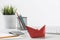 Wooden office desk with red origami boat