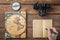 Wooden office desk table,  with .hand writing in empty notebook, .compass and an.analog camera. Photographer Personal Organizer