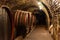 Wooden old barrels in the rustic wine cellar with brick walls in villany hungary