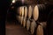 Wooden old barrels in the rustic wine cellar with brick walls in villany hungary