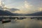 Wooden old empty colored boats on the lake Phewa on the background of a mountain evening valley in the fog