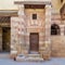 Wooden old grunge decorated door at courtyard of El Razzaz Mamluk era historic house, Darb Al-Ahmar district, Old Cairo, Egypt