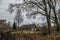 Wooden old house in bare forest