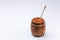 Wooden open barrel with fragrant liquid honey and honey stick on a white background. Close-up