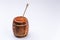 Wooden open barrel with fragrant liquid honey and a spoon on a white background. Close-up