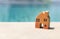 Wooden orange miniature house over blurred swimming pool background