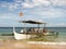 Wooden Outrigger Boat on a Beach Shore