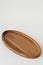 Wooden oval tray large on white background. Wooden utensils on white background. Dishes made of natural materials