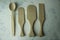 Wooden paddles and spoon on a white background under the concrete. View from above