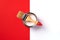 Wooden paint brush, open paint can on trendy red and white background. Top view, copy space. Appartment renovation